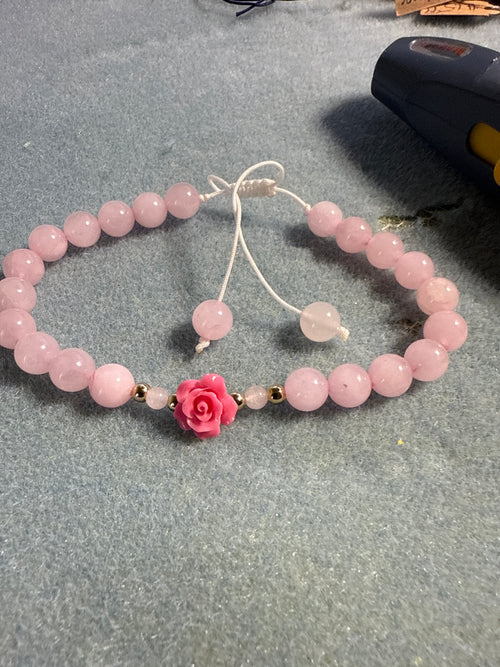 Pink rose quartz crystal bracelet with a pink rose charm 